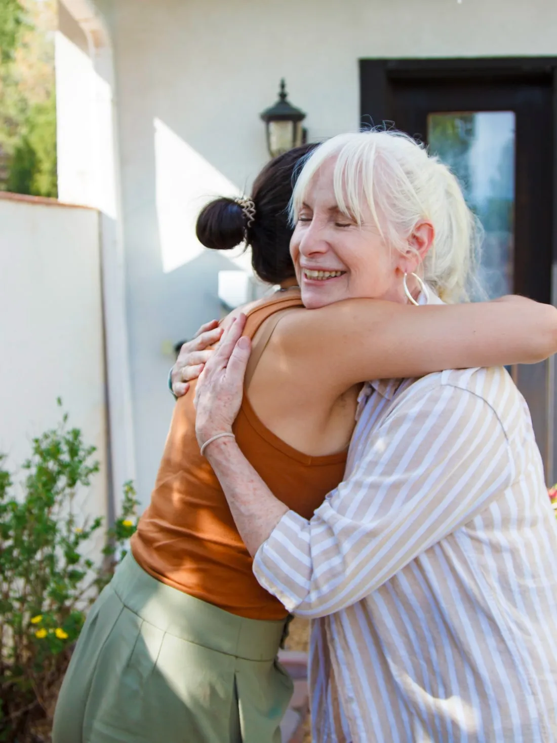 Janice Shayne hugging a client outside her office